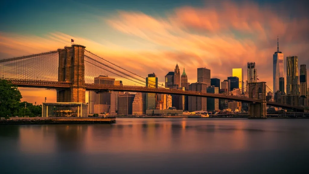 Brooklyn Bridge and the Lower Manhattan skyline above the East River at sunrise