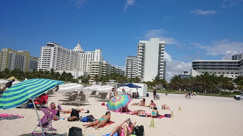 South Beach sand, umbrellas and waterfront buildings in Miami Beach