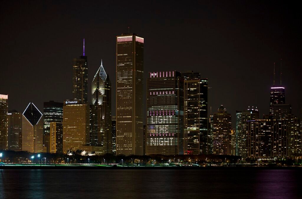 Chicago skyline illuminated at night beside Lake Michigan