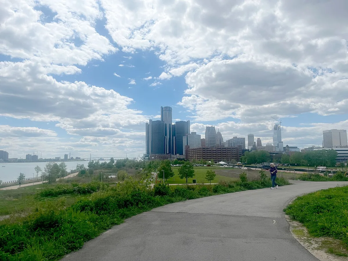 Detroit skyline beside a curving RiverWalk path