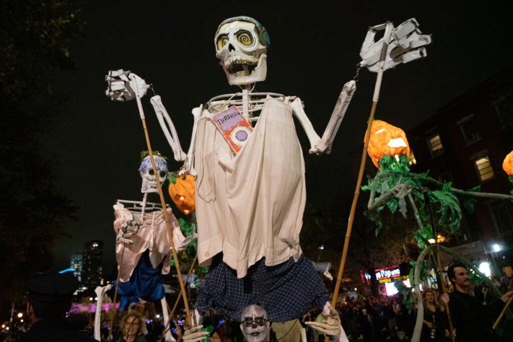 Costumed performers at the New York City Village Halloween Parade at night