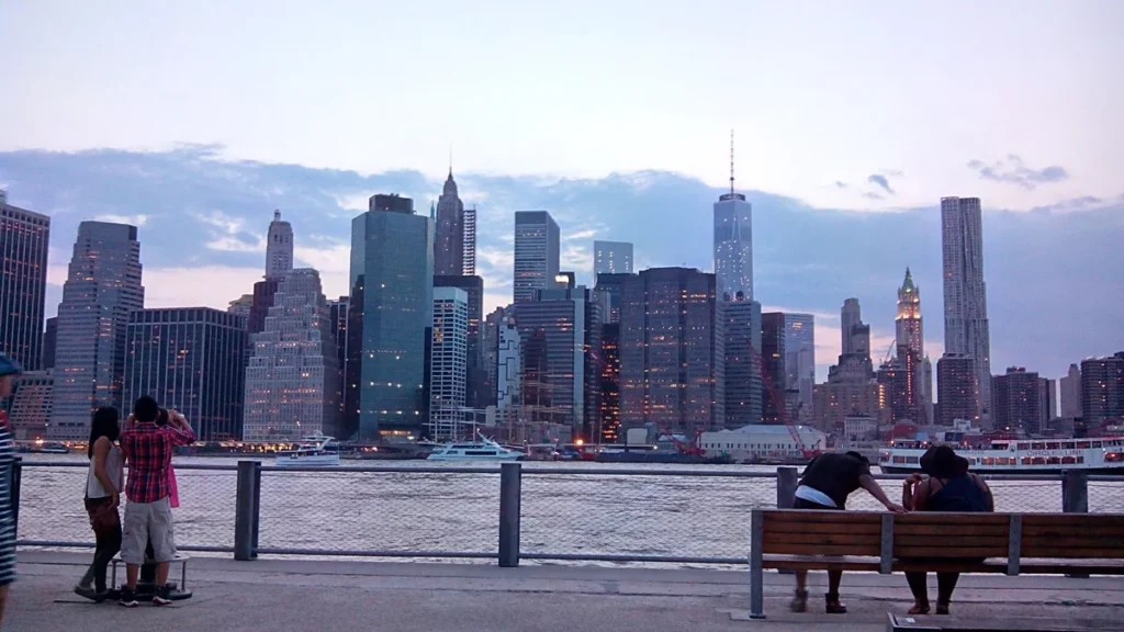 Lower Manhattan skyline at dusk viewed from Brooklyn Bridge Park